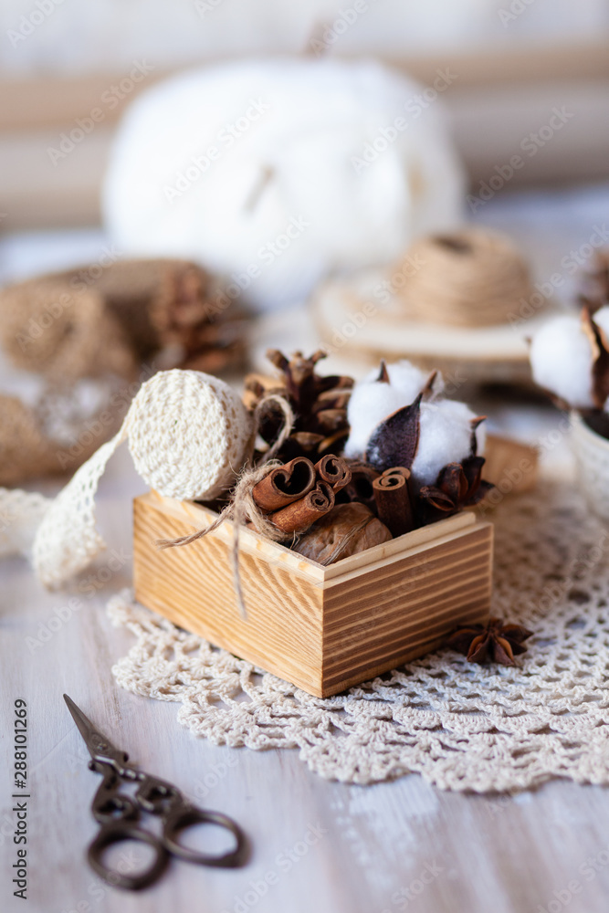 Family time to wrap christmas presents! Ideas for hand made gifts decor in rustic style, natural ingredients, cozy mood. Wooden background, scissors, lace, cones, cinnamon and cotton. Zero waste Family time to wrap christmas presents! Ideas for hand made gifts decor in rustic style, natural ingredients, cozy mood. Wooden background, scissors, lace, cones, cinnamon and cotton. Zero waste