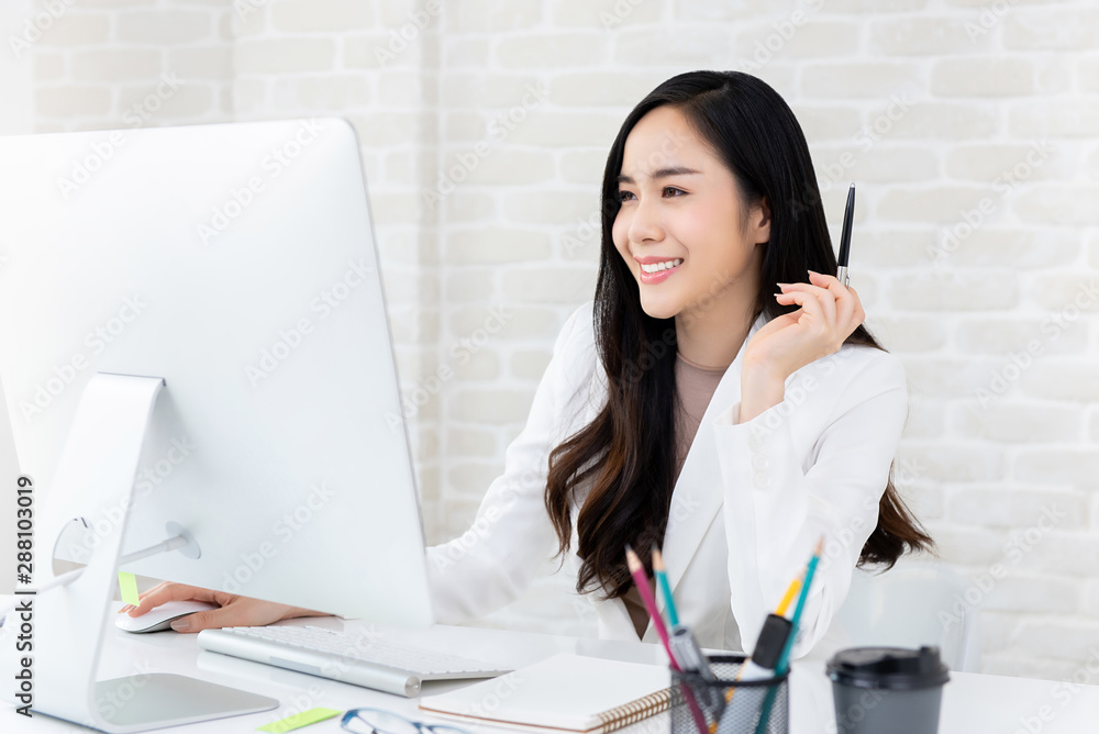 Beautiful working woman using computer in the office Beautiful working woman using computer in the office