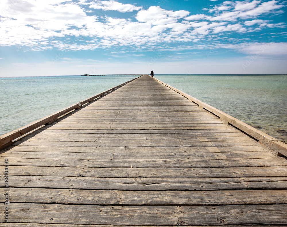 Fototapeta premium Wooden pier of free space for your decoration and blue sky with ocean landscape 