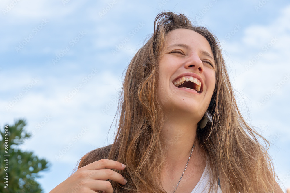 Cheerful woman outdoors smiling enthusiastically Cheerful woman outdoors smiling enthusiastically
