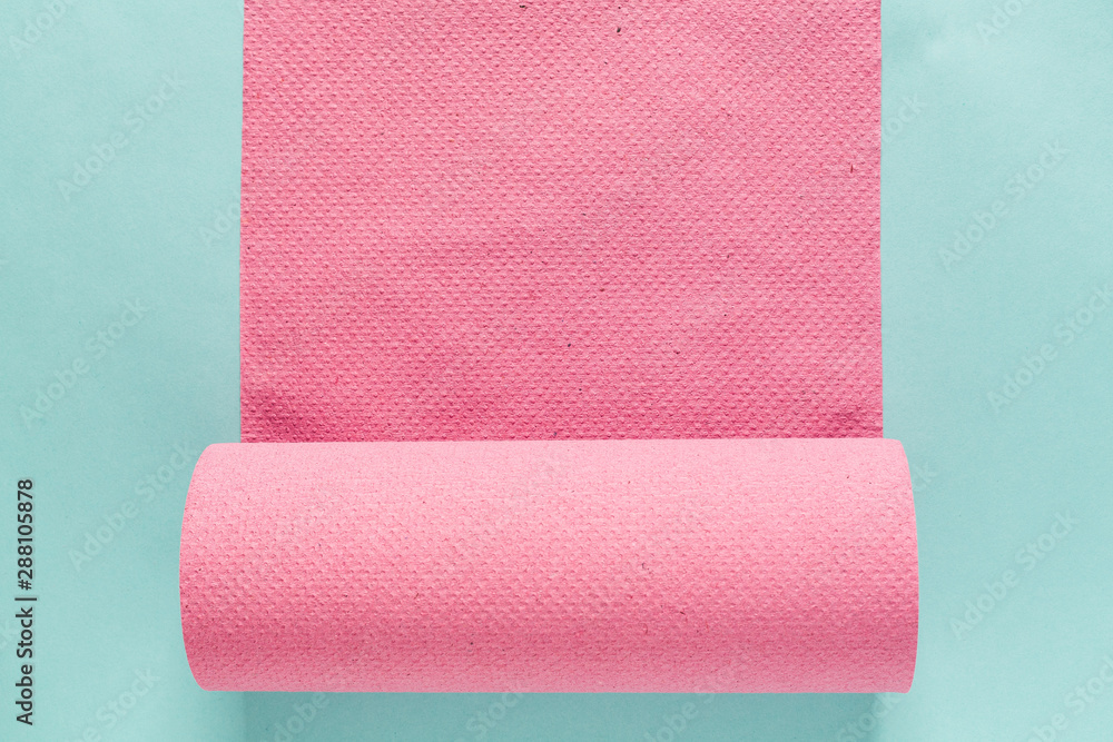 Obraz premium pink paper towels isolated on blue paper background. flat lay