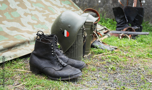 German army helmet and boots World War II period, outdoors photo