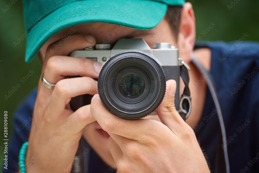 Man taking photos with retro style camera Man taking photos with retro style camera