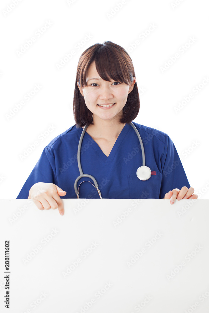 Young female nurse showing blank billboard isolated on white background Young female nurse showing blank billboard isolated on white background