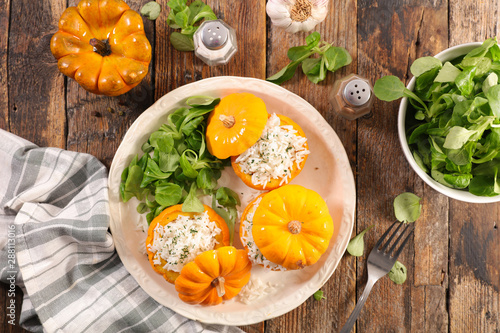 stuffed baked pumpkin with rice and salad