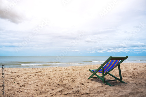 A single beach chair by the sea with blue sky background © Farknot Architect