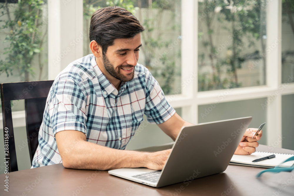 Portrait of focused young startup entrepreneur working with laptop in home ,start up concept. Portrait of focused young startup entrepreneur working with laptop in home ,start up concept.