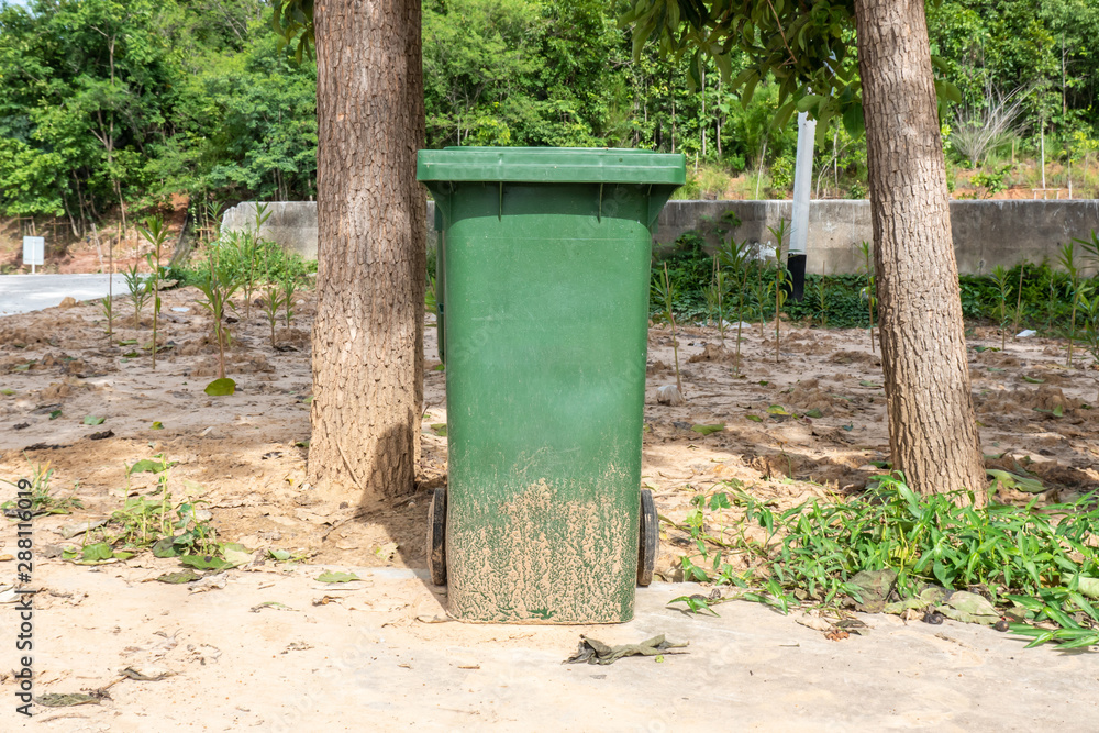 Green Plastic Trash with Wheels and Lid in Park Green Plastic Trash with Wheels and Lid in Park