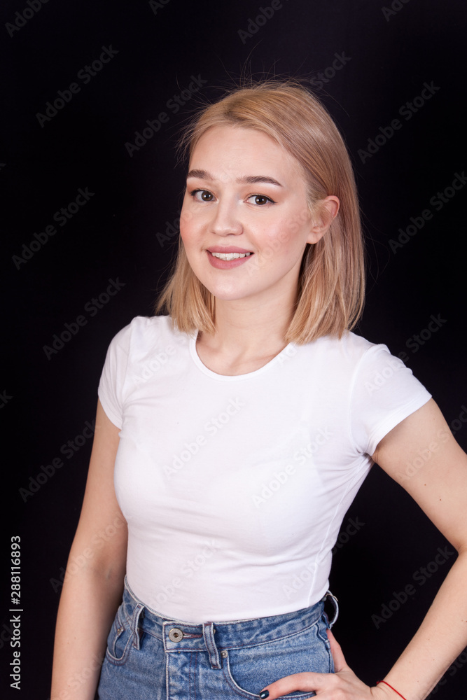 Young blonde woman smiling portrait on black background Young blonde woman smiling portrait on black background