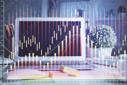 Financial chart drawing and table with computer on background. Double exposure. Concept of international markets. © peshkova