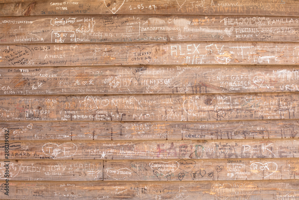 Messages scratched in a wooden wall Messages scratched in a wooden wall
