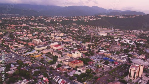 An aerial overview of Kingston, Jamaica. Taken during sunset from above the Pagasus Hotel. Panning from right to left. photo