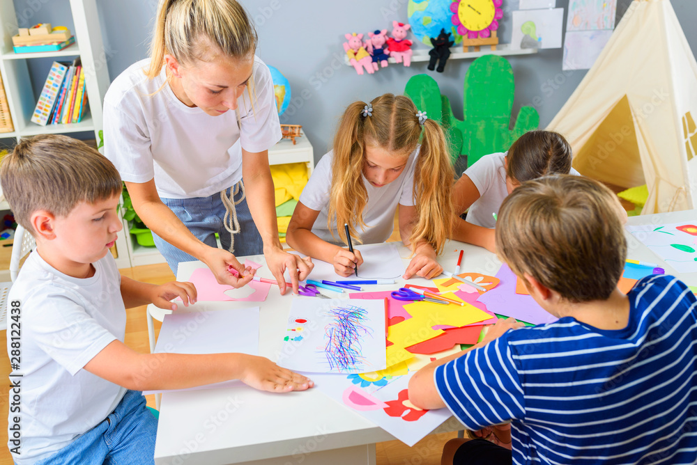 Fototapeta premium Preschool Teacher with Children at Kindergarten - Creative Art Class