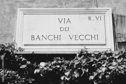 Rome, Italy - Via Dei Banchi Vecchi street sign. Black and white vintage style. photo