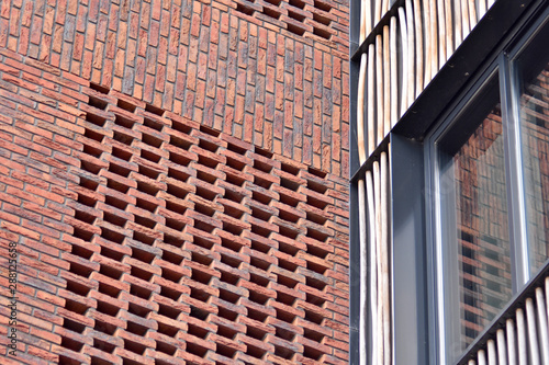 modern facade red brick urban building with corner view, fragment