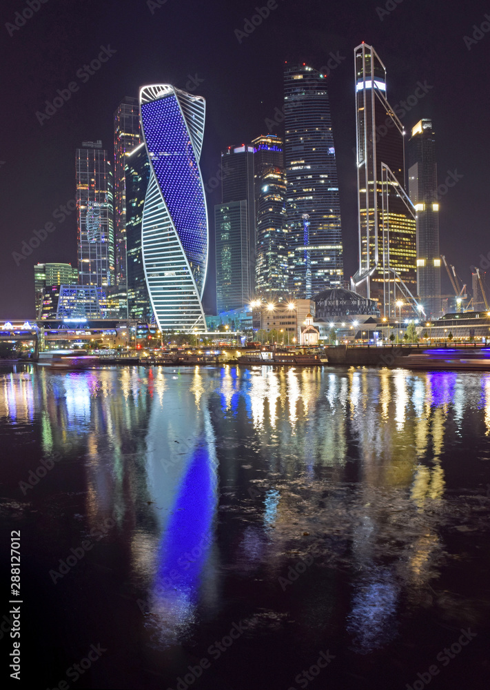 Naklejka premium High-rise buildings of the Moscow international business center Moscow-City on the bank of the Moskva River. The beginning of construction 1998. The construction continues. Russia, Moscow, August 2019