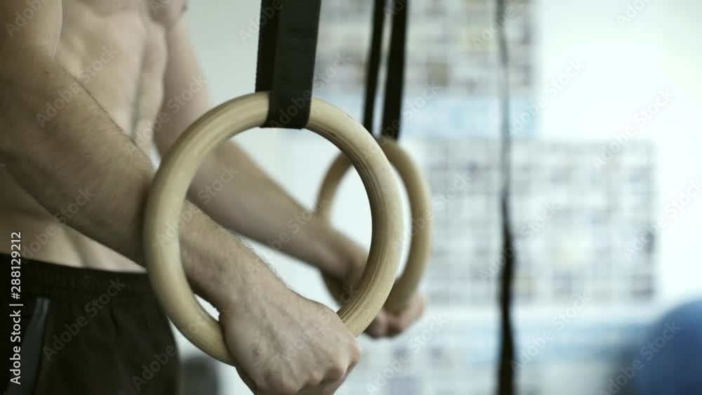 Athlete working out with gymnastic rings Athlete working out with gymnastic rings