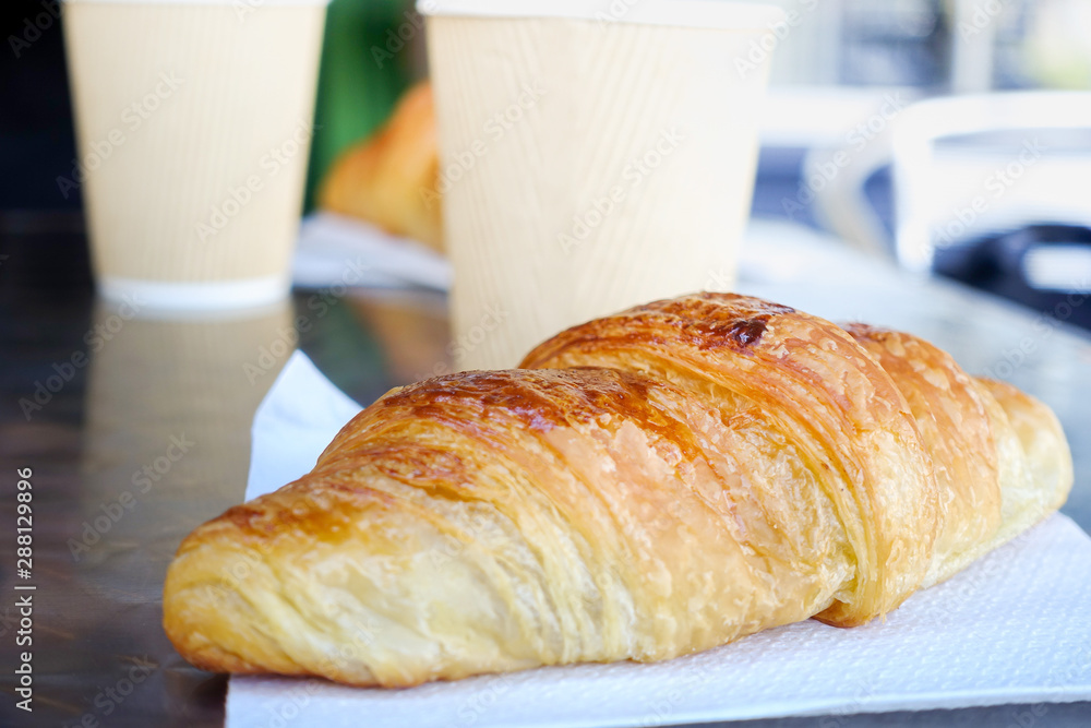 Breakfast with coffee and croissants on table - obrazy, fototapety, plakaty 