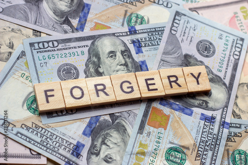 The word forgery on dollar usa background photo