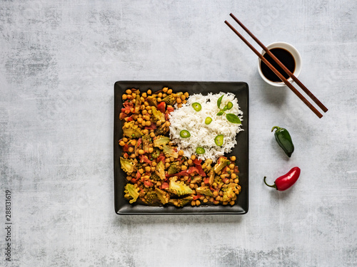Curry with chickpeas and cauliflower. Rice side dish. Asian cuisine. © sablinstanislav