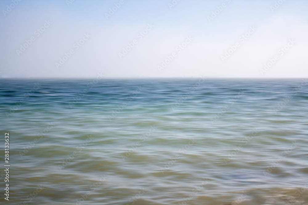 An abstract seascape with blurred panning motion with mussel rafts at the back An abstract seascape with blurred panning motion with mussel rafts at the back