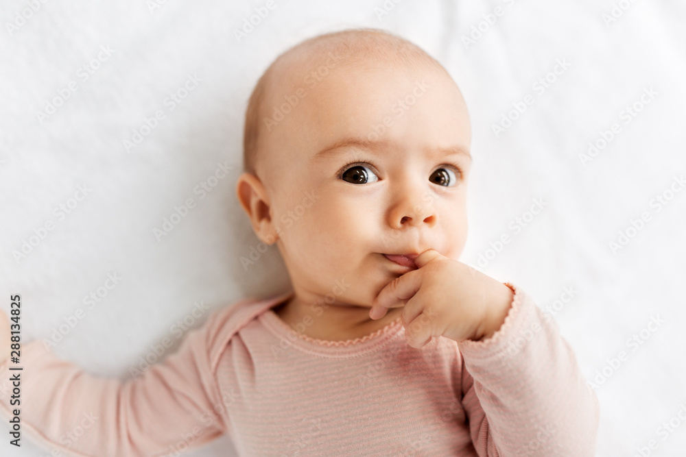 babyhood and people concept - sweet little baby girl lying on white blanket babyhood and people concept - sweet little baby girl lying on white blanket