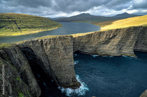 Dramatic landscape with Sorvagsvatn (or Leitisvatn) infinity lake over the ocean in Faroe Islands.