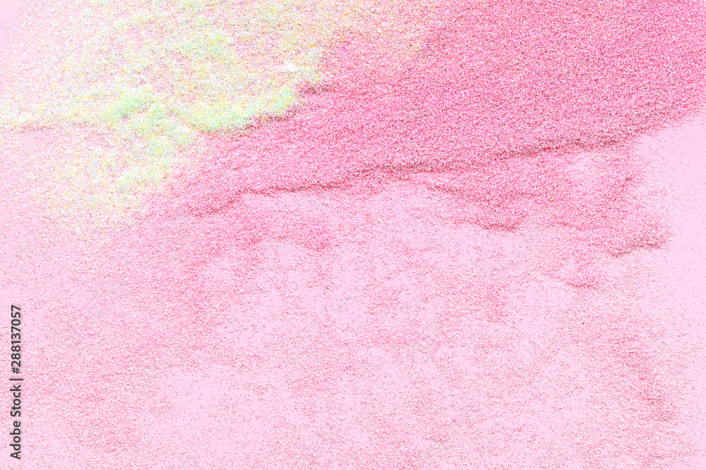 Many multi-colored spangles are scattered on a pink background. Many multi-colored spangles are scattered on a pink background.