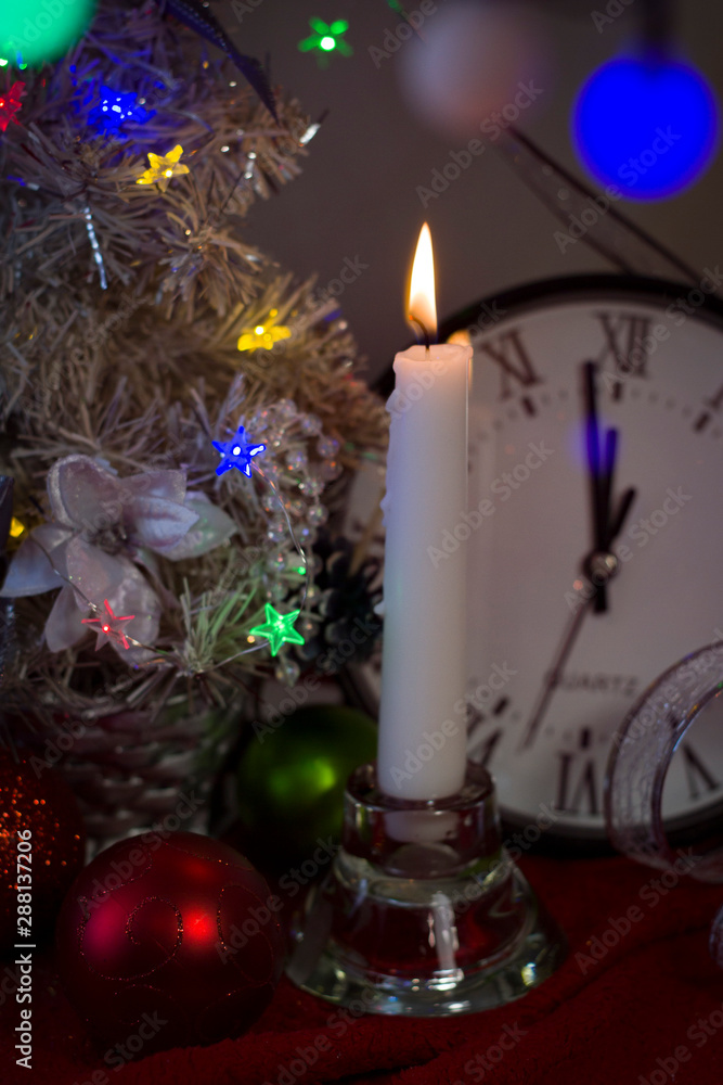  Happy New Year 2020. Christmas decorations with a clock of a Christmas fir tree on the background of lights and tinsel..