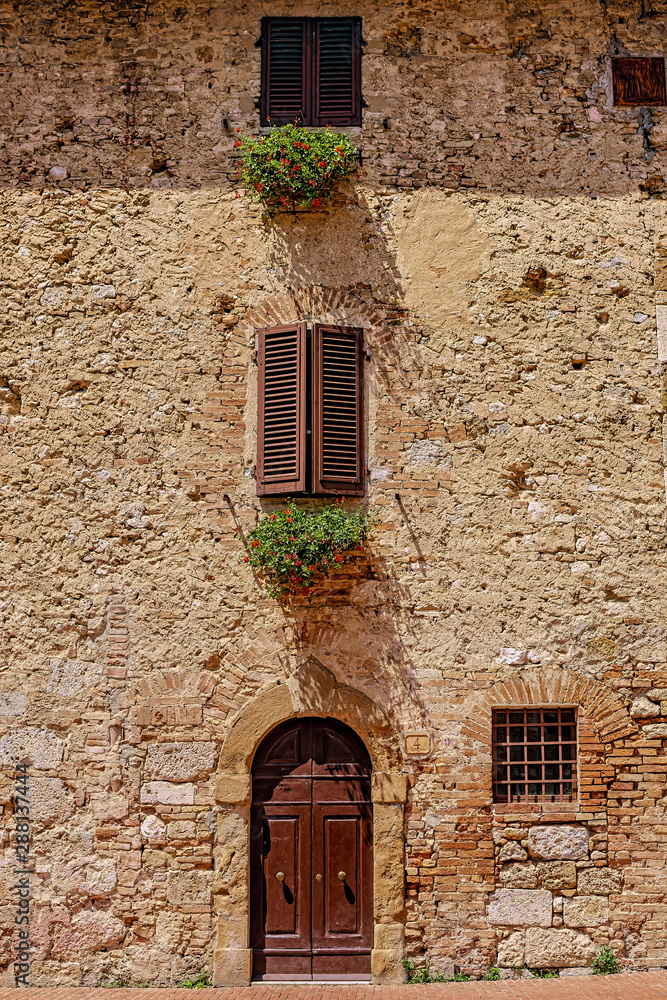 old wall with windows and door