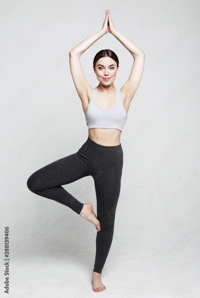 sport, yoga and people concept - lovely young woman doing yoga, sports exercises for relaxation and meditation sport, yoga and people concept - lovely young woman doing yoga, sports exercises for relaxation and meditation