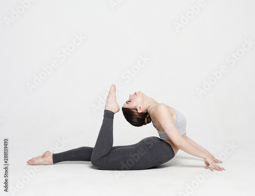 sport, yoga and people concept - lovely young woman doing yoga, sports exercises for relaxation and meditation