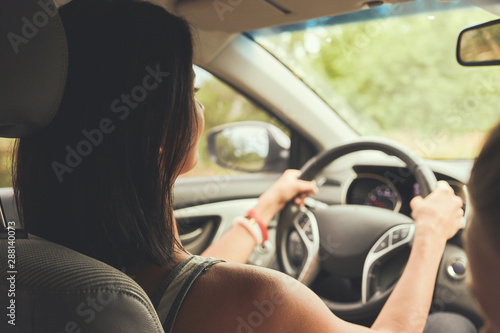 Woman driving a car. Rear view. © Андрей Репетий