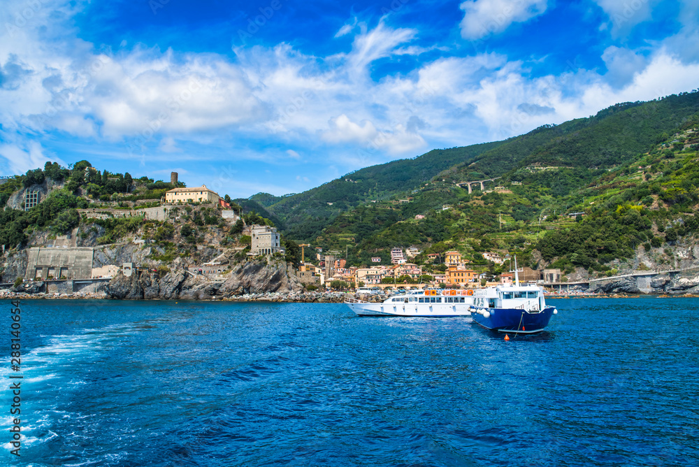 Monterosso al Mare, Cinque Terre, Italy - August 17, 2019: Boat trip along the sea coast, view of Monterosso al Mare, city buildings, sky and mountain peaks