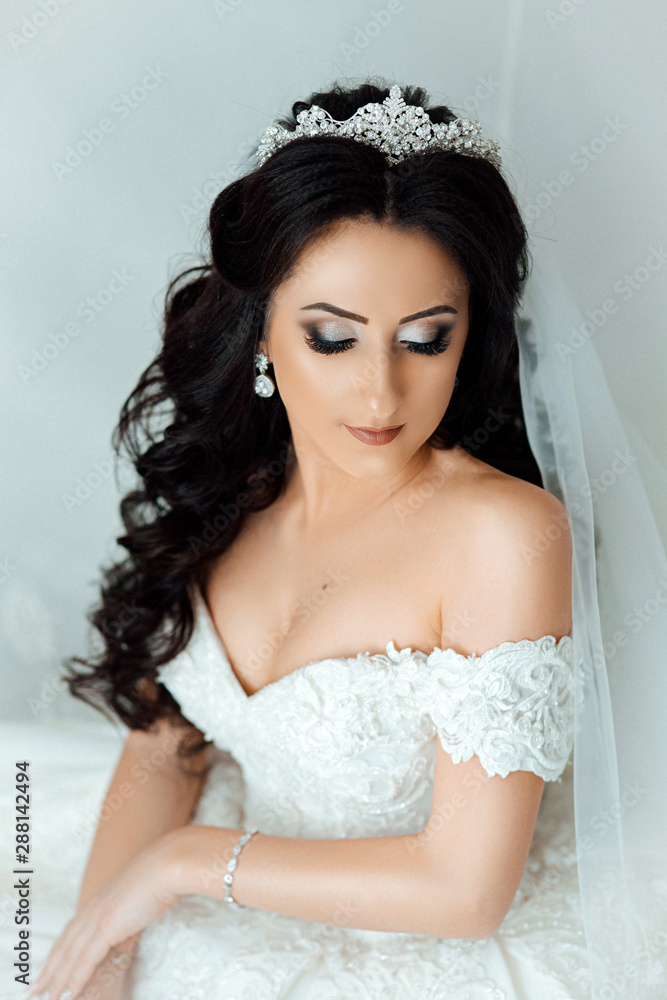 Face happy bride before the wedding. Portrait of a young girl with a beautiful smile. The bride smiles. Wedding day. Makeup and hairstyle. Morning preparation of the bride. Sexy bride Face happy bride before the wedding. Portrait of a young girl with a beautiful smile. The bride smiles. Wedding day. Makeup and hairstyle. Morning preparation of the bride. Sexy bride