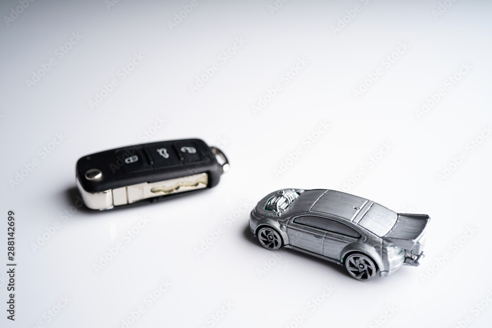 Car loan, Insurance, buy and sell and Auto Finance conceptual image with Car Key remote, die cast car and dollar bills Car loan, Insurance, buy and sell and Auto Finance conceptual image with Car Key remote, die cast car and dollar bills