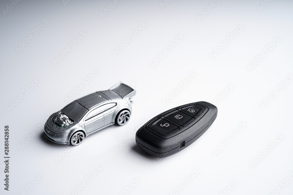Car loan, Insurance, buy and sell and Auto Finance conceptual image with Car Key remote, die cast car and dollar bills Car loan, Insurance, buy and sell and Auto Finance conceptual image with Car Key remote, die cast car and dollar bills