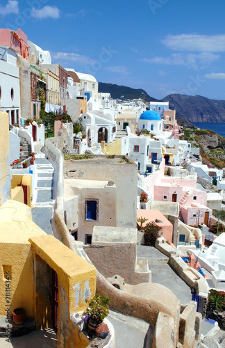 View of Oia, Santorini, Greece with colorful traditional houses. Santorini is famous for its colorful houses. Santorini colors are blue, white and yellow. Oia, Santorini, blue, white, yellow houses. photo