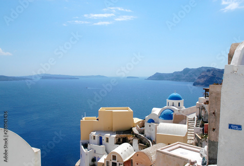 View of Oia, Santorini, Greece with the blue-domed Anastasis Church. The famous blue domed church of Santorini. White walls and blue dome is traditional in Santorini. Church, blue dome, Oia, Santorini