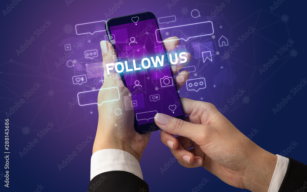 Female hand typing on smartphone with FOLLOW US inscription, social media concept Female hand typing on smartphone with FOLLOW US inscription, social media concept