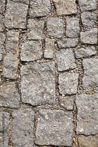 old pedestrian walkway on the street paved with stones