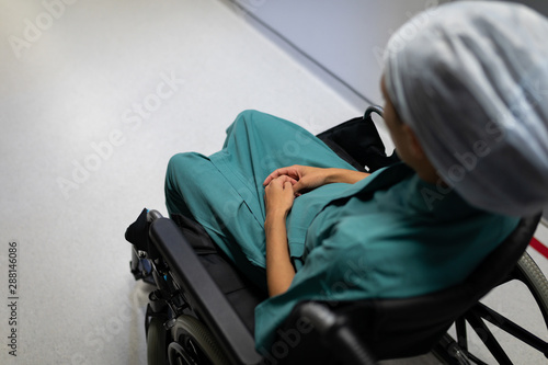 Female patient sitting on wheelchair 