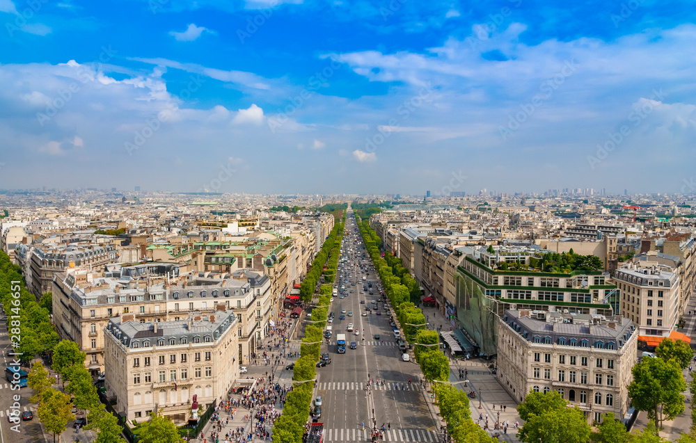 Lovely panoramic aerial view of the famous Avenue des Champs-Élysées in Paris on a nice sunny day with a blue sky at the horizon. It is one of the most recognisable avenues in the world.
