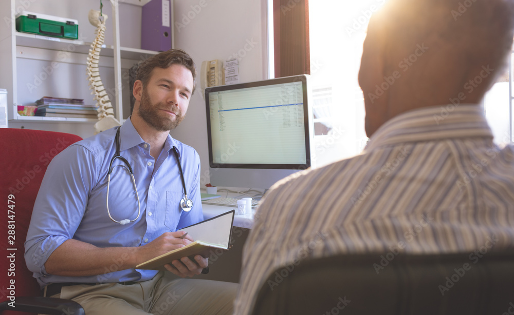 Fototapeta premium Male doctor and senior man interacting with each other in clinic