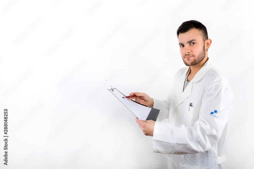 Young male doctor with beard pointing medical report isolated on white background Young male doctor with beard pointing medical report isolated on white background