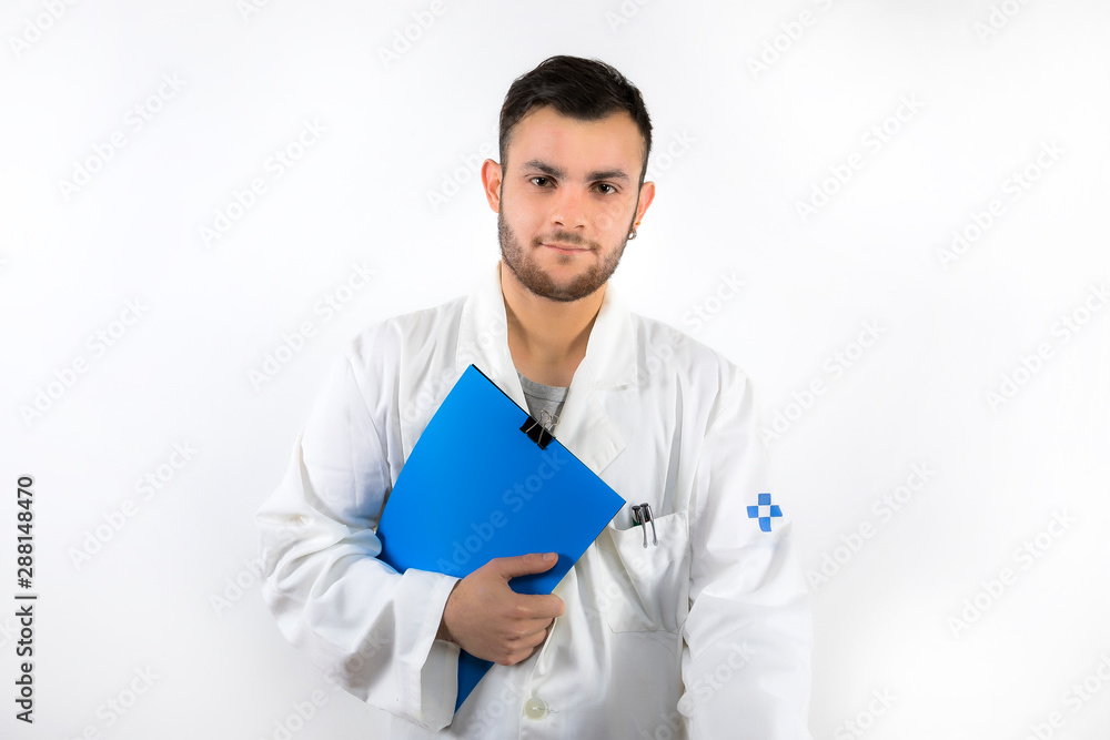 Young male doctor with beard holding medical report in hands isolated on white background