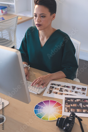 Female graphic designer working on computer at desk