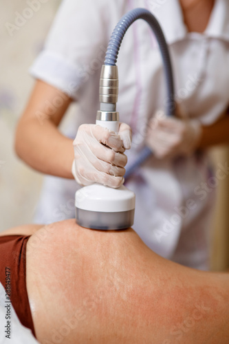 Fotografie Body treatment: woman getting rf lifting procedure to her buttocks