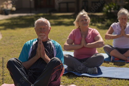 Senior people performing yoga in the park