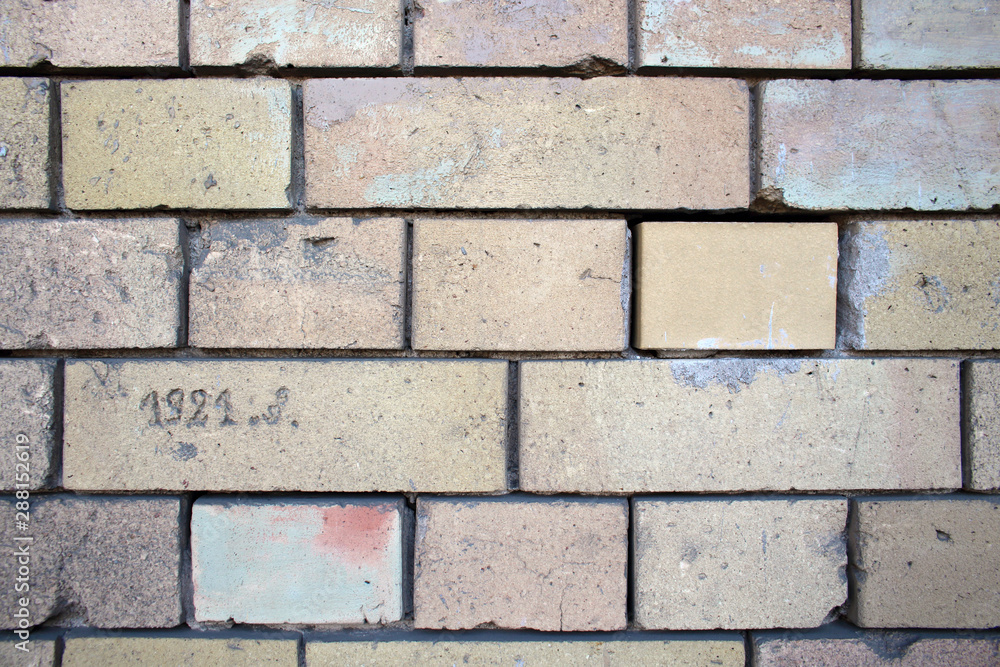 Fototapeta premium Light old building brick wall pattern design background with written date